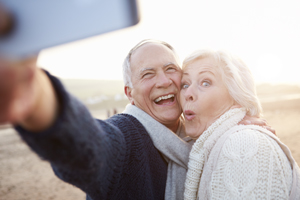 Older couple from Eagle, ID show off the dental crown and dental bridge they got near Meridian, ID.