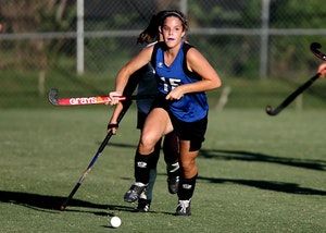 A young woman playing field hockey after sleep apnea treatment.